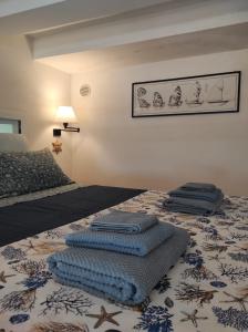 a bedroom with a bed with blue towels on it at La Tana in Formia
