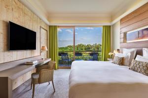 a hotel room with a bed and a desk and a window at Hôtel Barrière Ribeauvillé in Ribeauvillé +34 photos