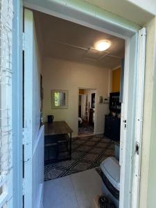 a living room with a toilet and a table at Central Eclectic Studio by ARPA Hospitalities in Stellenbosch +1 photo