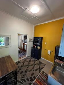 a room with a kitchen with a sink and a counter at Central Eclectic Studio by ARPA Hospitalities in Stellenbosch