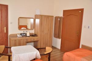 a small room with a bed and a mirror at Sanatorium Podhale in Połczyn-Zdrój