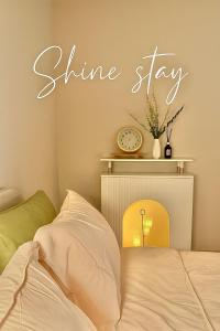 ein Schlafzimmer mit einem Shine-Schild an der Wand in der Unterkunft Shine Stay 5 Min from Songdo Moonlit Festiv Park Station in Taeam