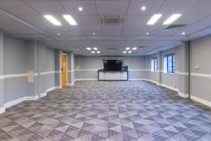 a large room with a flat screen tv in the middle at Holiday Inn Express Birmingham Airport NEC by IHG in Bickenhill