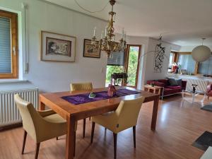 a dining room with a wooden table and chairs at Big Garden House in Feldkirch