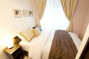 Postel nebo postele na pokoji v ubytování South Wind STAY Naha Uema