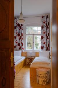 a room with two beds and a window at Villa Elbufer in Bad Schandau