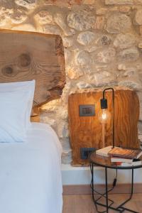 a bedroom with a bed and a table with a lamp at Corte Bonfiglio Colombari in Illasi