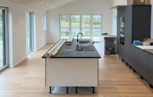 a kitchen with a sink and a counter top at 5 Bedroom Gorgeous Home In Karrebæksminde in Enø By