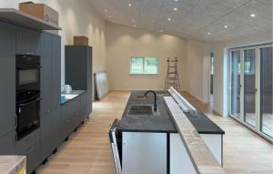 a kitchen with black cabinets and a counter top at 5 Bedroom Gorgeous Home In Karrebæksminde in Enø By