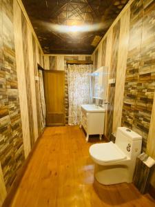 a bathroom with a toilet and a sink at Shanghai Palace in Srinagar +7 photos