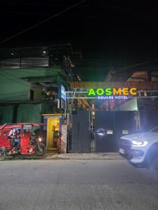 a car driving past a gas station at night at Aosmec Square Hotel in Mactan