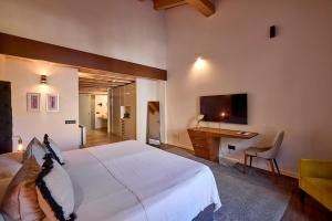 a bedroom with a large white bed and a desk at Hotel Bosch Boutique in Palma de Mallorca