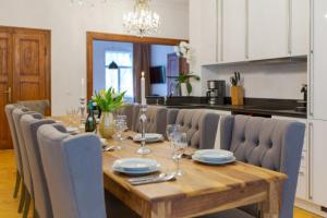 a dining room table with chairs and a table and a table at Villa Elbufer in Bad Schandau