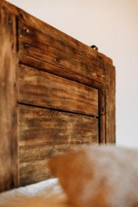 a close up of a wooden door on a wall at Vitalenta Agriboutique in Pienza +26 photos