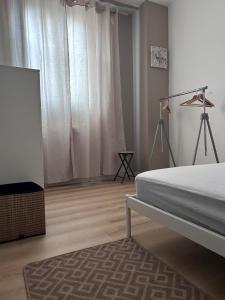 a bedroom with a bed and a television in it at Le Petit Cocon de Pleyben in Pleyben +23 photos