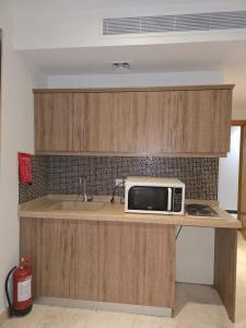a microwave sitting on a counter in a kitchen at برج الجوار السكني أجياد المصافي Jiwar Tower Ajyad Al Masafi in Al Gharīth