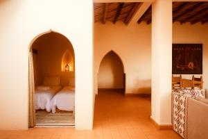 a bedroom with two archways with a bed in it at EdenAtlas Chambres d'hôtes - Amizmiz in Amizmiz