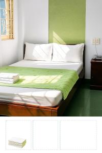 邦美蜀Sao Khue 2 Hotel的一间卧室，配有一张床和绿色墙壁