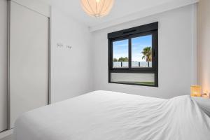 a bedroom with a white bed and a window at Casa Jette in San Miguel de Salinas +36 photos