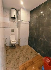 a bathroom with a toilet and a sink at Green View in Mussoorie +13 photos