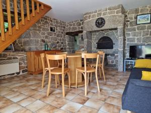 a kitchen with a table and chairs in a room at Gîte de la Capelle in Touluch +17 photos