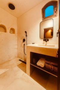 a bathroom with a sink and a mirror at EdenAtlas Chambres d'hôtes - Amizmiz in Amizmiz