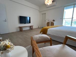 a bedroom with a bed and a flat screen tv at 靜沐森林 in Dongshan +23 photos