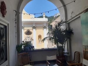 an archway in a building with a plant in a room at Casa Kenzia, in the heart of Minori in Minori +29 photos