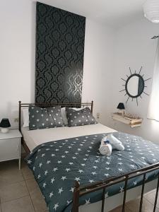 a bedroom with a bed with a clock on the wall at Eco Haus Milatos in Mesochórion