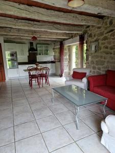 a living room with a couch and a table at La Fontaine d'Aubrac in Florentin-la-Capelle +20 photos