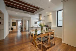 a kitchen and dining room with a glass table and chairs at Hotel Bosch Boutique in Palma de Mallorca
