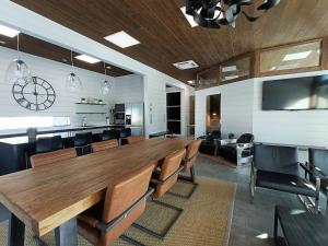 a conference room with a large wooden table and chairs at Top-equipped Kaarna Spa Villa in Inhantehtaat