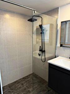 a shower with a glass door next to a sink at Villa l'Aurora in Amphoe Koh Samui