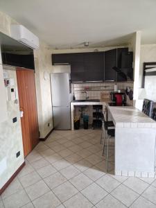 a kitchen with a counter and a refrigerator at Casa di Mike in Canegrate
