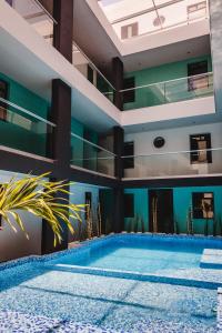 a swimming pool in the middle of a building at Hotel Flamingo Merida in Mérida