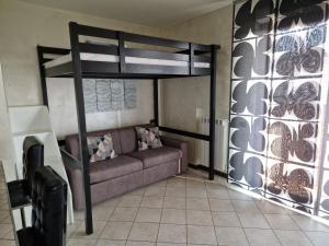 a living room with a couch and a bunk bed at Casa di Mike in Canegrate