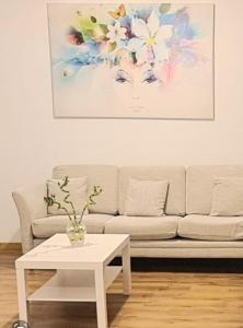 a living room with a couch and a table at Luma Haven in Şelimbăr