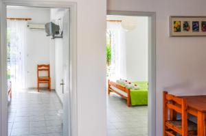 a room with a door leading to a bedroom at Olive Grove Apts in Lithakia