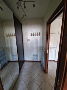 an empty room with two doors and a tile floor at Casa di Mike in Canegrate