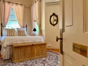 a bedroom with a bed and a window and a door at Kilkivan Homestead in Kilkivan