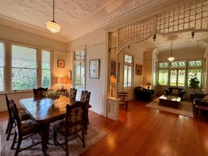 a living room with a wooden table and chairs at Kilkivan Homestead in Kilkivan
