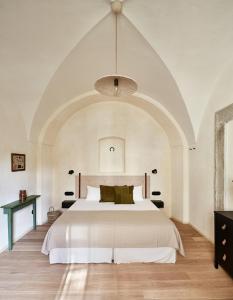 a bedroom with a large bed with an arched ceiling at Zámek Žďár in Žďár nad Sázavou
