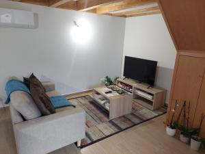 a living room with a couch and a flat screen tv at Casa da Fraga in Soajo
