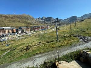 a dirt road in the middle of a field with buildings at Immodelpas Pic Blanc in Pas de la Casa