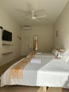 Postel nebo postele na pokoji v ubytování Cerya Kampung Inn + 5 fotografií