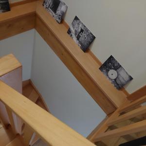 an overhead view of a wooden staircase with framed pictures at Casa da Fraga in Viana do Castelo