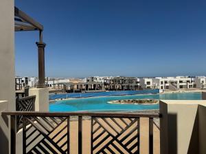a view of a swimming pool from the balcony of a resort at 3 bedrooms penthouse with sea view in Hurghada