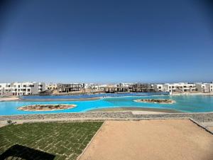 a view of a swimming pool with buildings in the background at 3 bedrooms penthouse with sea view in Hurghada