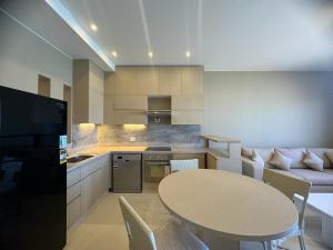 a kitchen and living room with a table and a couch at 3 bedrooms penthouse with sea view in Hurghada