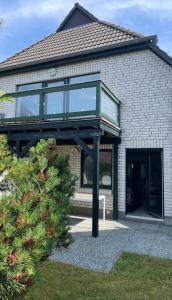 a house with a glass balcony on top of it at Veermaster in Breege